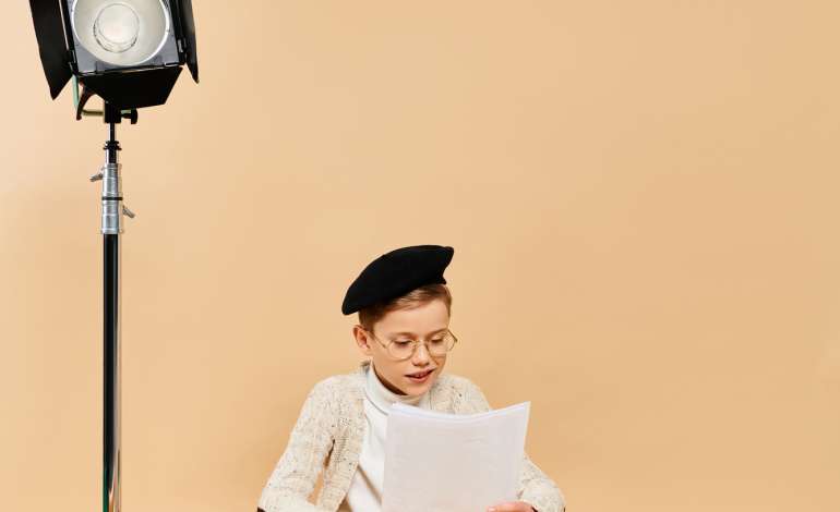 A boy sitting in front of a camera.