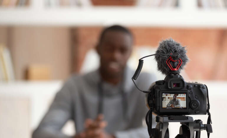 Vlogger sitting in front of a video camera. Orlando Video Production Company, NG Production Films